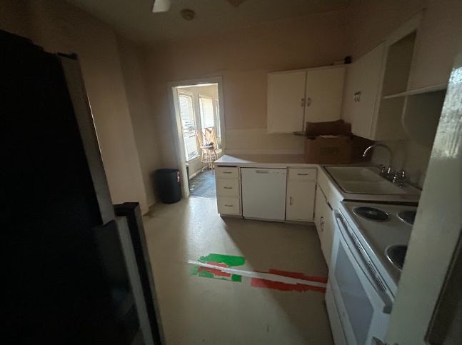 Dated kitchen with white cabinets