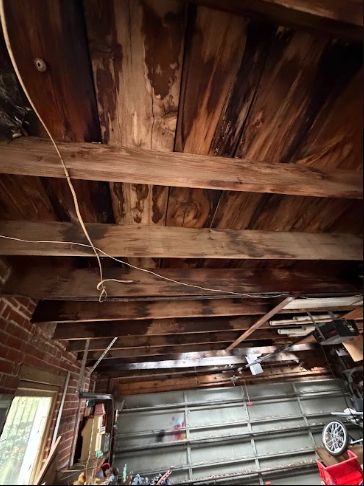 Detached garage roof rafters with water staining