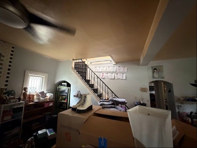 Staircase with wrought iron rail and leaded glass window